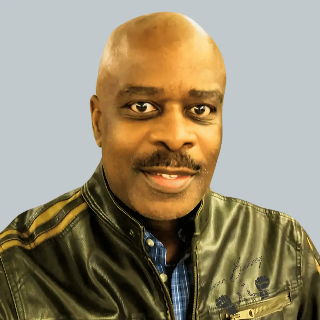 Sylvan Barzey - CEO and Co-founder of Captivation Suite A professional photo of Sylvan Barzey, CEO and co-founder of Captivation Suite, wearing a mud-green leather jacket against a sleek, tech-inspired background in shades of silver blue.